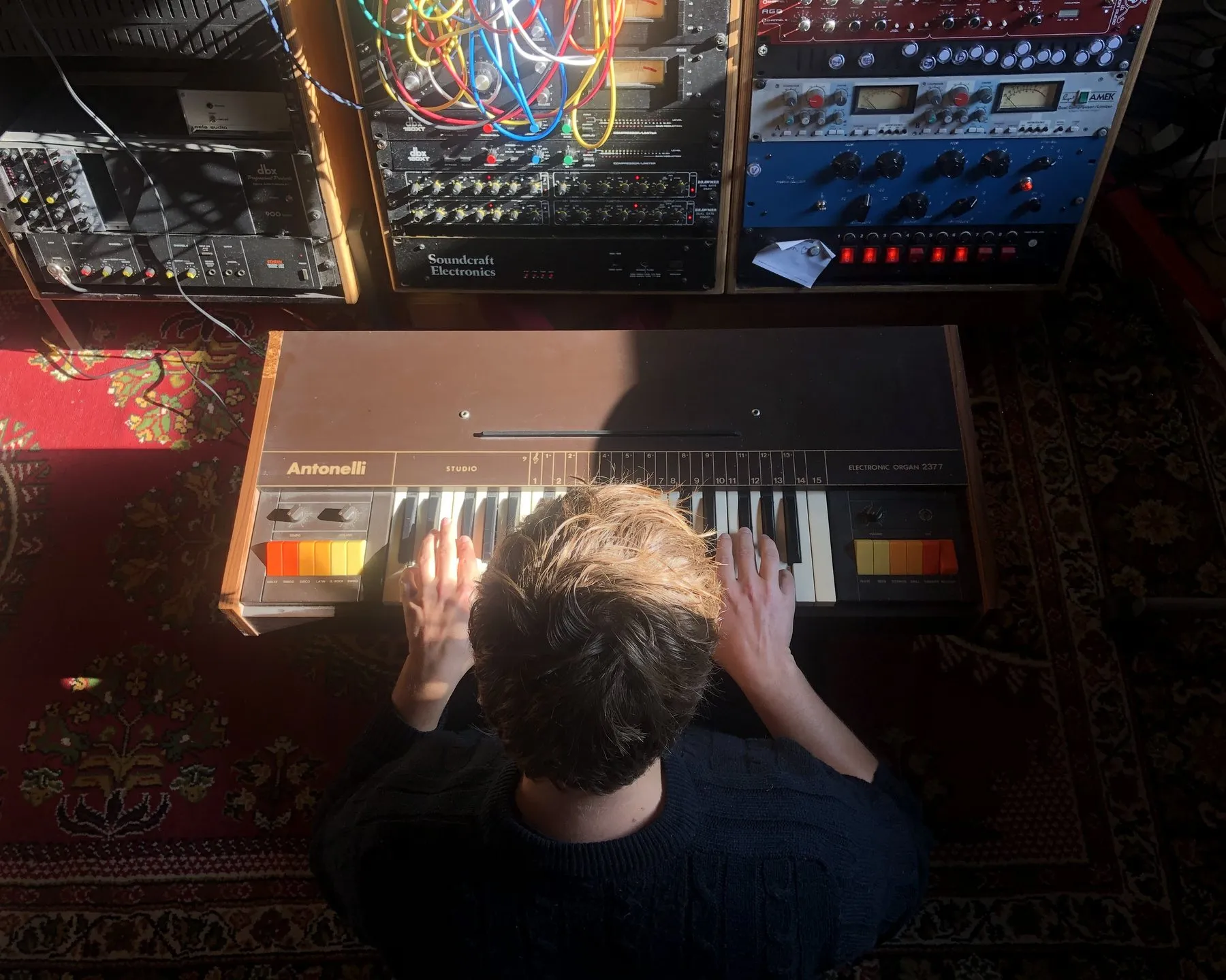 Playing a vintage Antonelli organ below a rack of outboard gear, seen from above